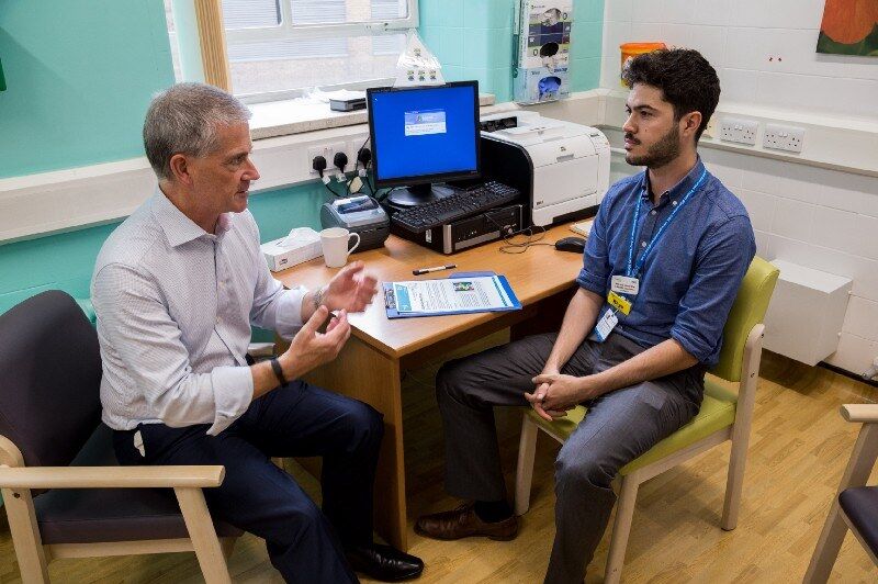 Simon talking to a doctor in the doctor's office at Guy's Hospital