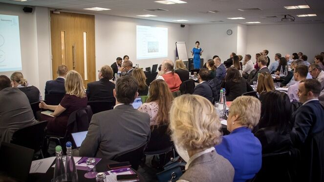 Seminar room full of participants listening to a talk
