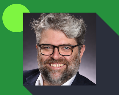 Headshot of Rob Annan on green background