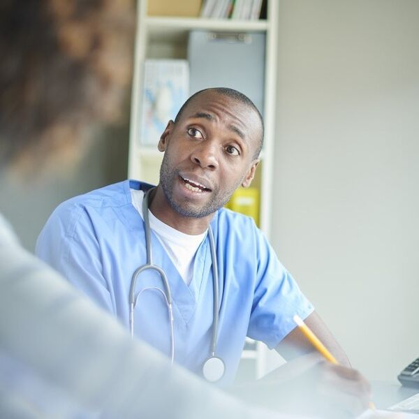 Black male doctor speaking to patient