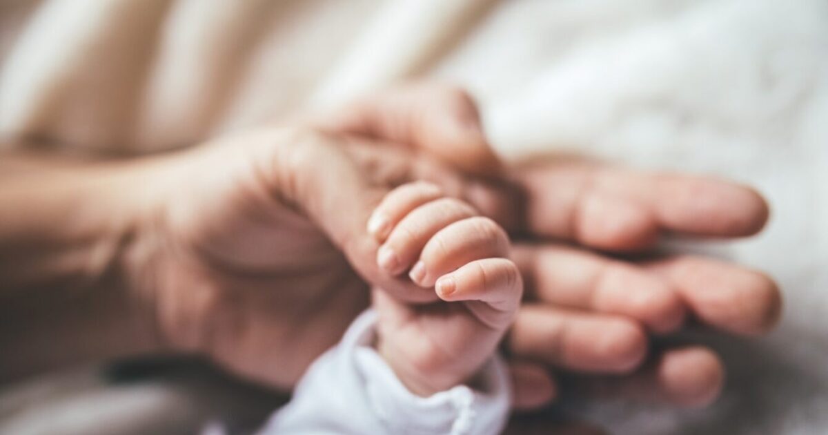 Newborn-and-adult-hands.jpg?